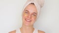 Feminine pampering. Glowing complexion. Skin moisturizer. Satisfied happy woman in bath towel showcases her beauty regimen
