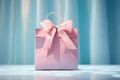 Feminine pink shopping bag with ribbon bow on blue background, springtime or summer sale and Valentine surprise offer promotion