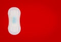 Feminine sanitary napkin with blue liquid drops on red background Royalty Free Stock Photo