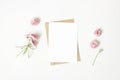 Feminine stationery, desktop mock-up scene. Vertical blank greeting card, craft paper envelope and daisy bouquet and