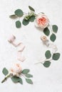 Feminine wedding, birthday still life scene. Silk ribbons, eucalyptus leaves and blush pink English roses flowers
