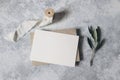 Feminine wedding stationery, desktop mock-up scene. Blank greeting card, craft envelope with olive branch and silk Royalty Free Stock Photo