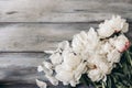Feminine wedding table composition with white peonies flowers on old shabby wooden background. Empty copy space. Flat Royalty Free Stock Photo