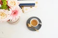 Feminine workplace concept in flat lay style with coffee, flowers, notebooks on white marble background. Top view, bright, pink an Royalty Free Stock Photo