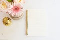 Feminine workplace concept in flat lay style with flowers, golden pineapple, notebook on white marble background. Top view, bright Royalty Free Stock Photo