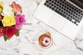 Feminine workplace concept. Freelance fashion comfortable femininity workspace in flat lay style with laptop, tea, flowers on whit