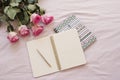 Feminine workplace concept. Freelance fashion comfortable femininity workspace in flat lay style with open notebook, pink rose flo