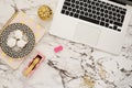 Feminine workplace concept. Freelance workspace in flat lay style with laptop, sweets, golden pineapple, notebook and paper clips Royalty Free Stock Photo
