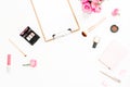 Feminine workspace with pink roses bouquet, cosmetics, diary and clipboard on white background. Top view. Flat lay. Beauty blog, c Royalty Free Stock Photo