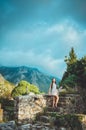 Feminine young romantic woman walking in Old Bar, Montenegro. Brunette female with long hair posing on ancient ruins