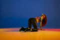 Femininity. Young girl dancing heels dance in stylish clothes over blue background in neon with mixed lights. Concept of Royalty Free Stock Photo