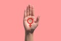 Feminism icon in hand on pink background, power of women background concept Royalty Free Stock Photo