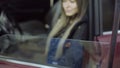 feminized blonde car service master girl sitting in an old car