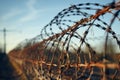 Fence adorned with barbed wire, marking a restricted zone perimeter Royalty Free Stock Photo
