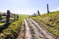 Fence along the country road through hillside Royalty Free Stock Photo