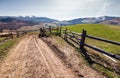 Fence along the country road in rural area Royalty Free Stock Photo