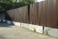 Fence around construction fence made of metal profile. Brown steel profile