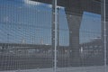 Fence around the harbor of Calais, with profile of fly over roads behind