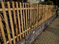 the fence around the house is made of split bamboo. half logs screwed Royalty Free Stock Photo