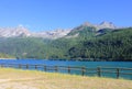 Fence around the lake in front of mountains Royalty Free Stock Photo