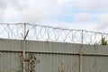 Fence with barbed wire against the sky Royalty Free Stock Photo