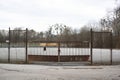 Fence and barrier made of metal, gate and door is closed by lock and chain Royalty Free Stock Photo