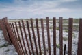 Fence on beach with natural vegetation and sand Royalty Free Stock Photo