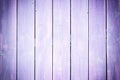 Fence of boards painted in violet. Background with the texture of wooden slats. Royalty Free Stock Photo