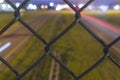 Fence With Bokeh Of Lights At Overpass