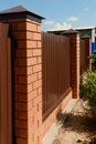 Fence with brick pillars and metal profiled