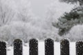Fence built from wood. Outdoor landscape. Winter background. Snowy nature blurred background with fence. Royalty Free Stock Photo