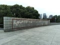 Fence of The Bund Historical Museum Tower in Shanghai, China with trees behind