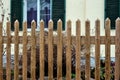 Garden fence made of wood. Tensile slats are designed to prevent climbing over the fence