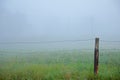 Fence and Fog at spring morning Royalty Free Stock Photo