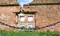 Fence in front of the destroyed wall. The concept of conservation of attractions