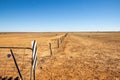 Fence and gate in the arid Australian outback Royalty Free Stock Photo
