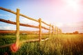 Fence in the green field under blue cloud sky Royalty Free Stock Photo