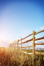 Fence in the green field under blue cloud sky Royalty Free Stock Photo