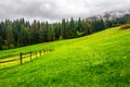 Fence on hillside meadow in mountain Royalty Free Stock Photo