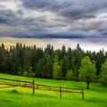 Fence on hillside meadow in mountain Royalty Free Stock Photo