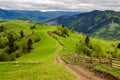 Fence on hillside meadow in mountain Royalty Free Stock Photo