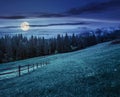 Fence on hillside meadow in mountain at night Royalty Free Stock Photo