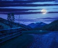 Fence on hillside meadow in mountain at night