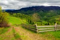 Fence on hillside meadow in mountain