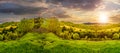 Fence on hillside meadow in mountain at sunset Royalty Free Stock Photo