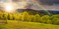 Fence on hillside meadow in mountain at sunset Royalty Free Stock Photo