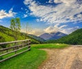 Fence on hillside meadow in mountain