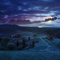 Fence on hillside near forest in mountain in full moon light Royalty Free Stock Photo