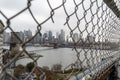 Fence Hole on Manhattan Bridge with downtown Manhattan on the Background