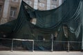 a fence with a large metal structure behind it